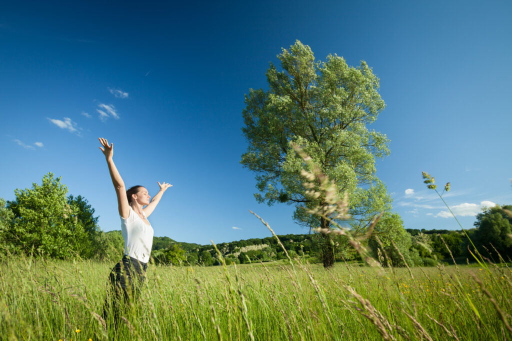 woman relaxing and focusing on mental health in nature